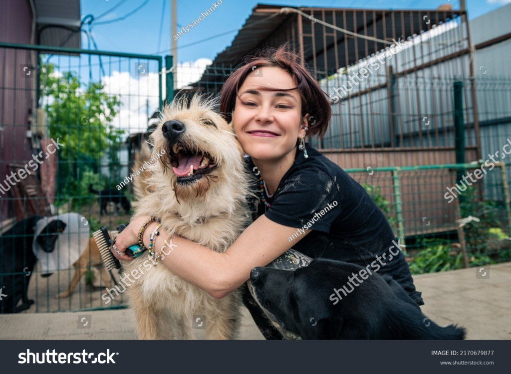 Volunteer at animal shelter playing with the dog
